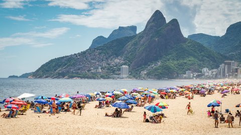 Rio de Janeiro, Brazil - December 9, 2021: Zoom in time lapse view of famous Ipanema beach during summer in Rio de Janeiro, Brazil. 