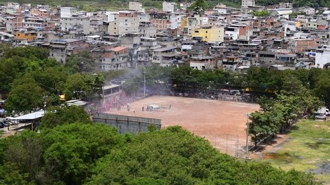 Helicopter on soccer field in favela. Arrival of Santa Claus for give gifts to the children.