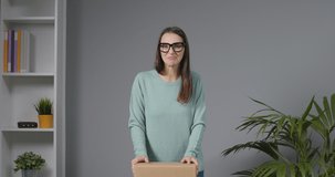 Professional influencer shooting an unboxing video, she is opening the box and talking to her followers