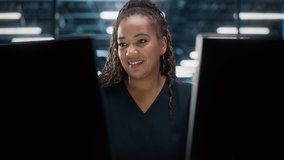 Portrait of African American Female IT Specialist Working on Desktop in Data Center. System Administrator Works on Web Services, Cloud Computing, Server Analytics, Cyber Security Maintenance, SAAS - Powered by Shutterstock - Get 15% off with code: PIKWIZARD15