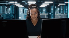 Call Center Office: Portrait of Friendly African American Female Technical Customer Support Specialist Talking on a Headset, uses Computer. Client Experience Officer Helps Online via Video Conference - Powered by Shutterstock - Get 15% off with code: PIKWIZARD15