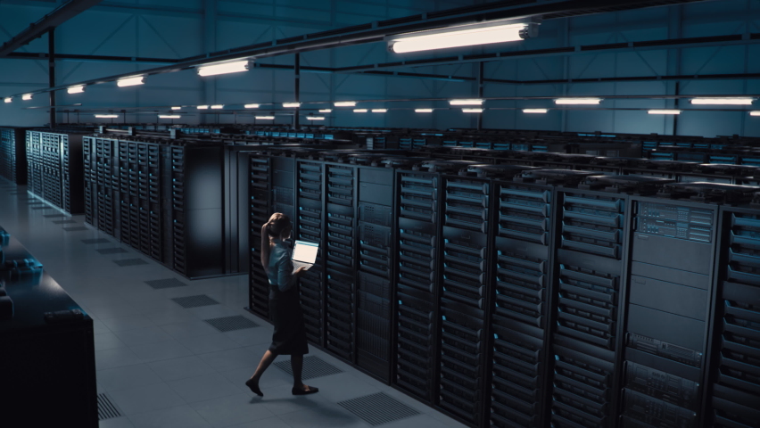 Animated Concept: Big Data Center Female Chief Technology Officer Using Laptop Standing In Warehouse, Activates Servers, Information Digitalization Starts. SAAS, Cloud Computing, Web Service | Shutterstock HD Video #1084218181