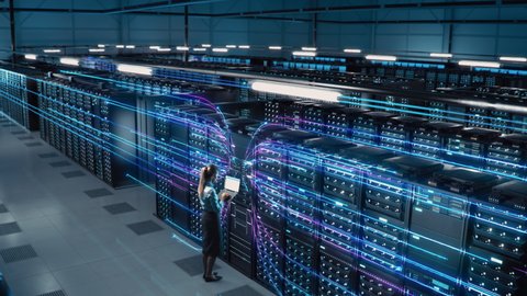 Animated Concept: Big Data Center Female Chief Technology Officer Using Laptop Standing In Warehouse, Activates Servers, Information Digitalization Starts. SAAS, Cloud Computing, Web Service