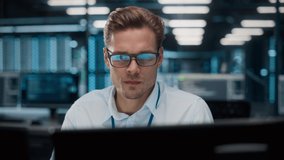 High-Tech Data Center Server Control: IT Specialist Administrator Working on Computer, Screen Showing Advancing Big Data AI Analysis. Web Services, Cloud Computing, Analytics Facility, Cyber Security - Powered by Shutterstock - Get 15% off with code: PIKWIZARD15