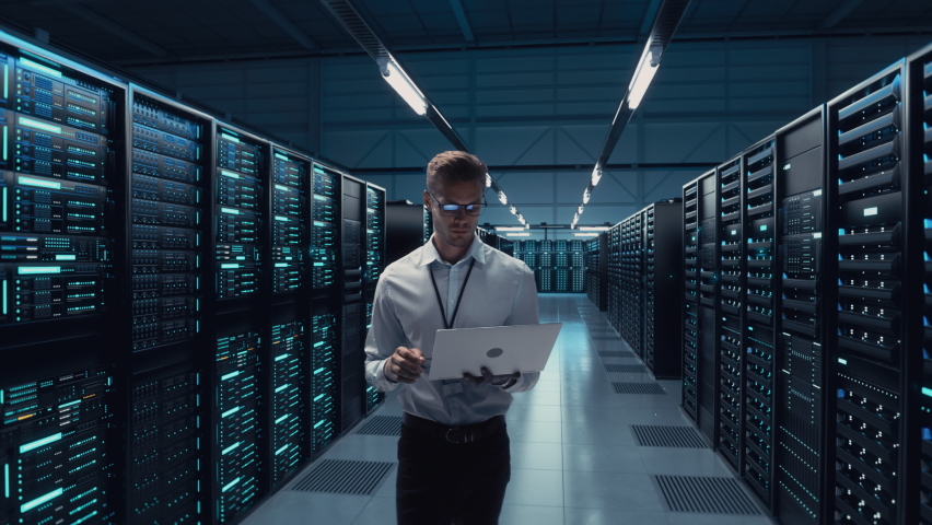Futuristic Animated Concept: Big Data Center Chief Technology Officer Using Laptop Standing In Warehouse, Information Digitalization Lines Streaming Through Servers. SAAS, Cloud Computing, Web Service Royalty-Free Stock Footage #1084218220