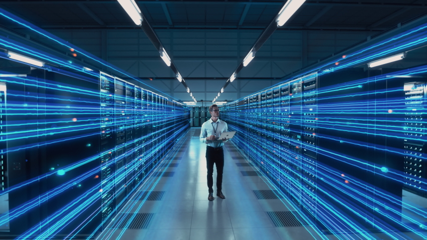 Futuristic Animated Concept: Big Data Center Chief Technology Officer Using Laptop Standing In Warehouse, Information Digitalization Lines Streaming Through Servers. SAAS, Cloud Computing, Web Service