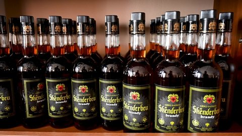 Albania, October 2021: A shelf full of alcoholic beverages. Hard liquor. Skenderbeg, most popular alcohol dring in Albania. Skënderbeu cognac