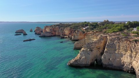 Delightful aerial view of Portuguese rocky beaches near the city of Portimao. For the rest of tourists. Algarve.