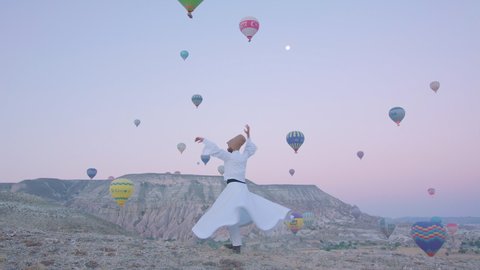 NEVSEHIR, TURKEY 2019 Whirling dervish.Memorial week of Mevlana who is Muslim Sufi of 13th century. Sebi Arus means "Reunion Night". Hot air balloons colourful Flying over rock mountain valley Göreme.