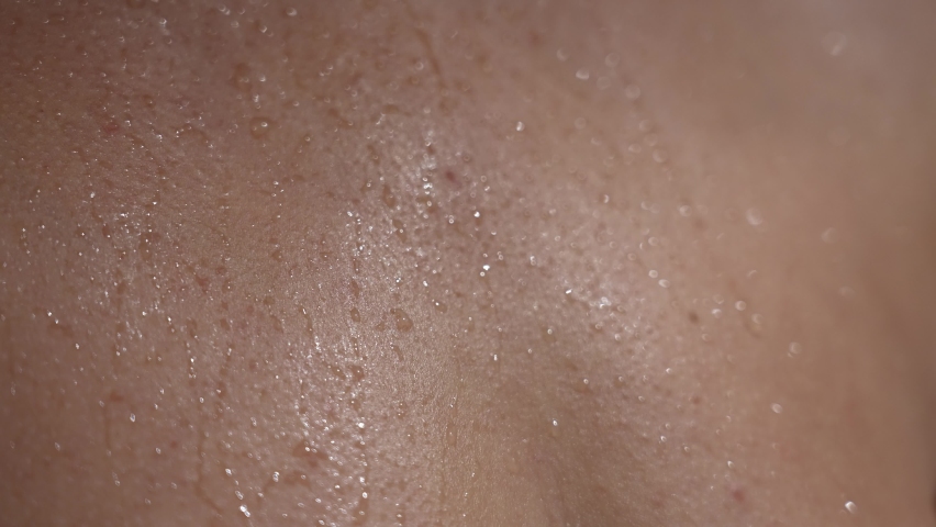 Close-up view 4k stock video footage of wet from waterdrops female human skin texture Royalty-Free Stock Footage #1084232569