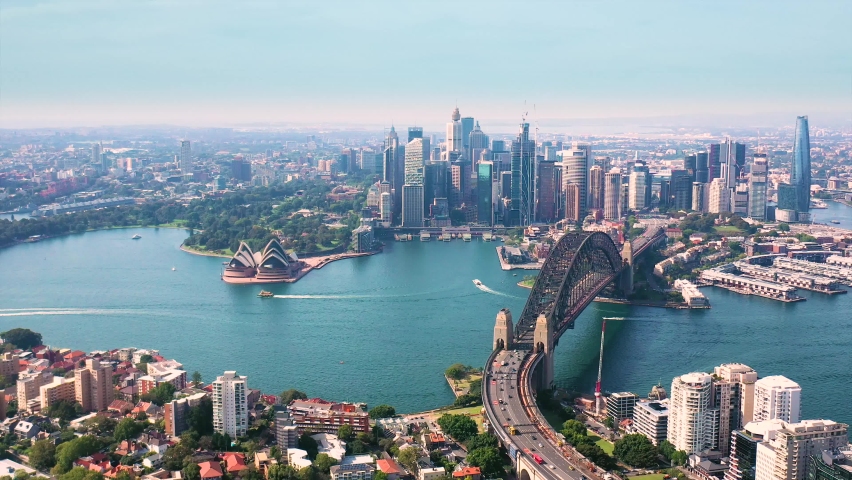 Aerial drone panoramic view of Sydney City, the Sydney Harbour and the Harbour Bridge looking from North Sydney  Royalty-Free Stock Footage #1084234858