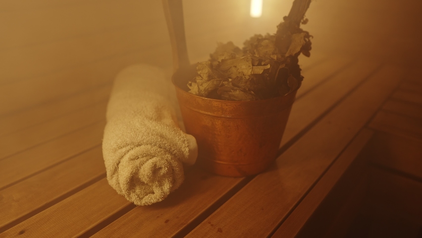 Bucket with bath broom and towel in sauna. Royalty-Free Stock Footage #1084235008