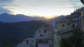 The Rising Sun Illuminates the Roofs of a Medieval Town in the Mountains
