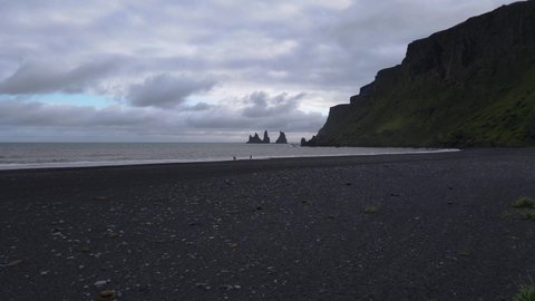 Beautiful cinematic aerial view of the famous Black Sand Beach seen from the town of Vic in Iceland 