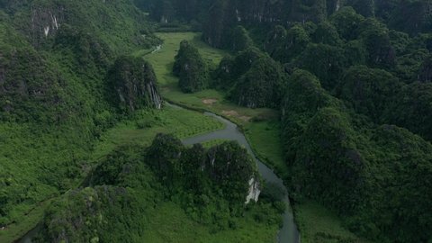 aerial drone shot of panoramic view rising by drone of mountains landscape of Ninh Binh National park in Vietnam. Unesco world heritage site, wild nature.