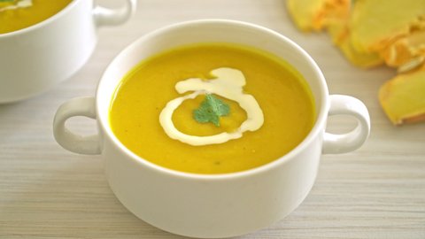 pumpkin soup in white bowl - Vegetarian and vegan food style