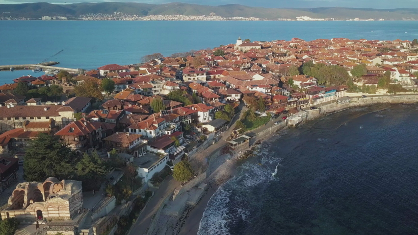Bird's Eye View Of Ancient City Of Nessebar On Black Sea Coast In Bulgaria With Mountainous Landscape In Background. aerial tilt-up