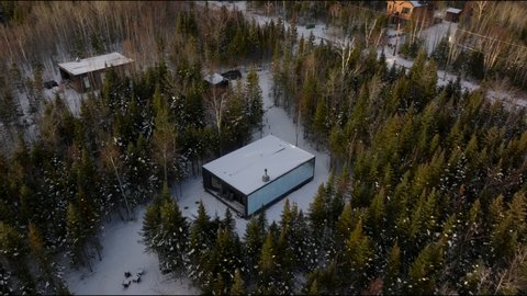 View Of Glamping Cabins Amongst Lush Pine Trees In Charlevoix, Quebec Canada. Aerial Drone