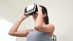 Training with virtual sport at home. Young asian sport woman wearing sportswear workout with virtual simulated world. Into the future digital cyber universe. Future technology vr.