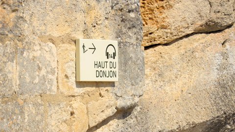Les Baux-de-Provence, France - August 2021 : "top of the Donjon" audio guide sign in the chateau of Les Baux de Provence in summer in France