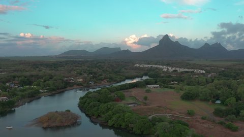 Landscape of a pacific island with boats and lagoon in aerial view sunset. Tamarin, Mauritius.