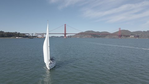 Aerial view of a Sailboat yacht in San Francisco bay. Golden Gate on the background