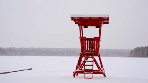 Lifeguard watch tower in winter beach, USA. Rescue red station, waterfront watchtower hut, ocean coast atmosphere. Rescue tower
