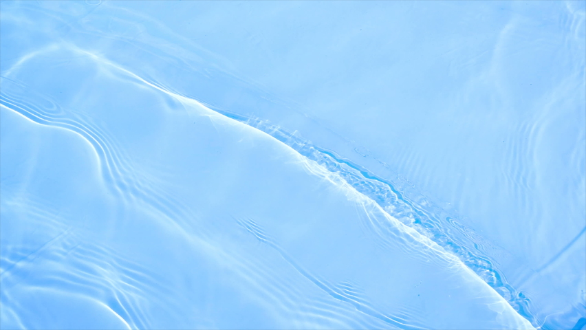 Slow motion clean Water Surface 
Texture ripples and wave, Water Caustic Background. Refraction of sunlight top view texture sea side white sand, sun shine water background.  Water Caustic Background.
