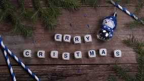 Christmas composition with pine needles and lettering cubes with congratulation - Merry Christmas on wooden boards - Powered by Shutterstock - Get 15% off with code: PIKWIZARD15