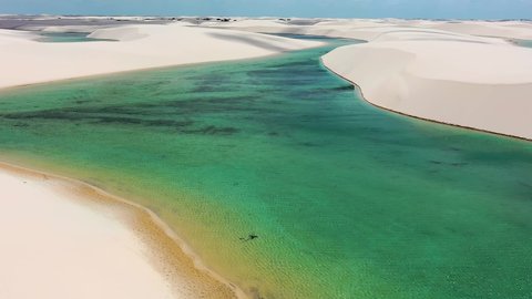 Paradisiac waves scenery of rainwater lakes and sand dunes of Lencois Maranhenses National Park Brazil.