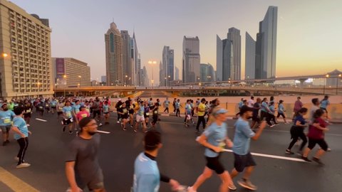 Dubai , United Arab Emirates - 11 26 2021: People Run At Sheikh Zayed Road With Skyscrapers In Background At Sunrise