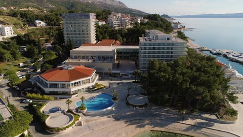 Split , Croatia - 01 11 2018: Coastal hotel building with football field and luxury yachts in Croatia, Split city, aerial drone view