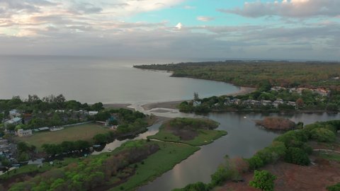 Landscape of a pacific island with boats and lagoon in aerial view sunset. Tamarin, Mauritius.