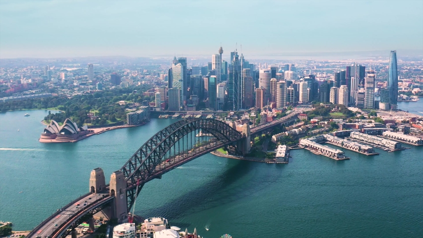Aerial drone panoramic view of Sydney City, the Sydney Harbour and the Harbour Bridge looking from North Sydney  Royalty-Free Stock Footage #1084261654