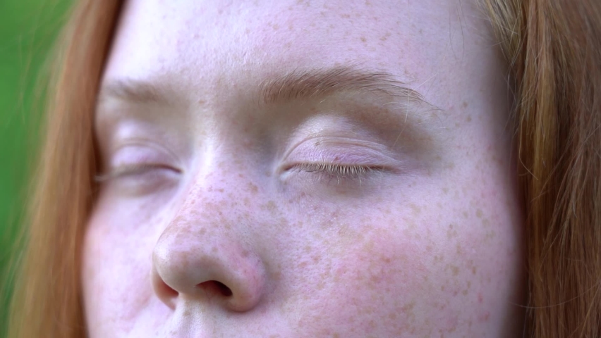 Beautiful eyes of a redhead girl close up. Slowmotion