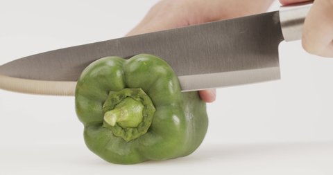 Chef hand releases green bell peppers after cutting. The inside was filled with large seeds.