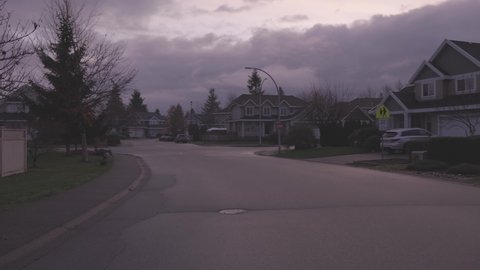 Fraser Heights, Surrey, Vancouver, British Columbia, Canada - December 5, 2021: View of Residential Suburban Neighborhood Street in a modern city. Frosty Cloudy Morning Sunrise Sky.
