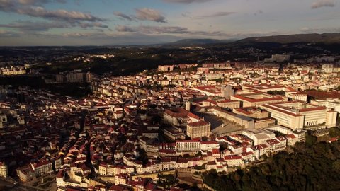Aerial view of coimbra university city in Portugal drone fly above the center during golden hour