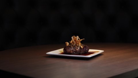 Mouthwatering Gourmet Sirloin Steak with Fried Onions at Fancy Restaurant