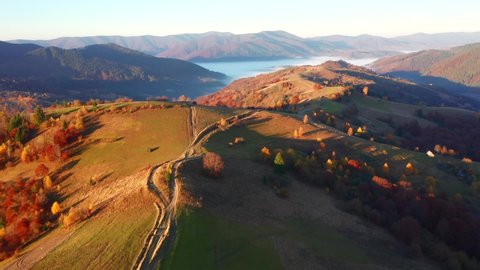 Autumn day in the mountains from a bird's eye view. Shooting from a quadcopter. Location place Carpathian mountains, Ukraine, Europe. Cinematic aerial shot. Beauty of earth. Filmed in 4k, drone video.