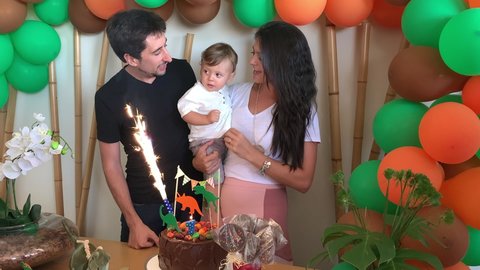 Parents celebrating baby one year old birthday singing