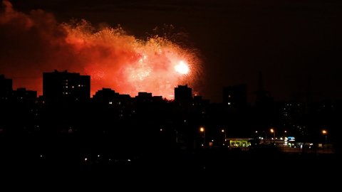 Beautiful fireworks, celebration, silhouette of night cityscape.