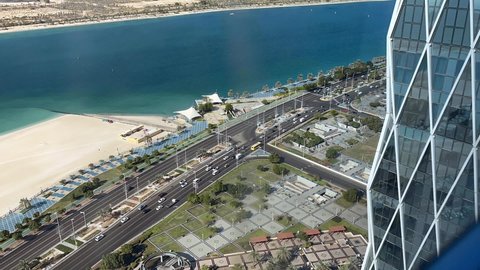 Aerial high view of Abu Dhabi city (UAE) from downtown, Abu Dhabi corniche road and beach
- Abu Dhabi, UAE, December 6, 2021