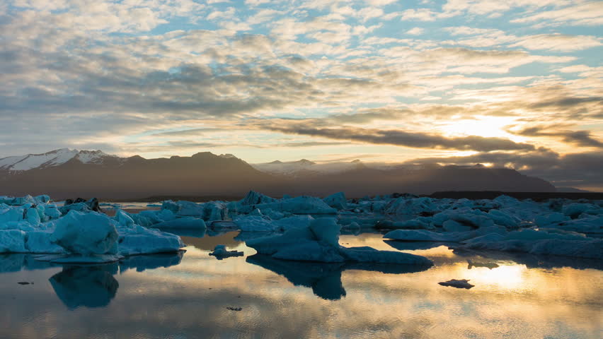 Amazing Time Lapse of Drifting Icebergs and the Sunrise. Slow Zoom Out.