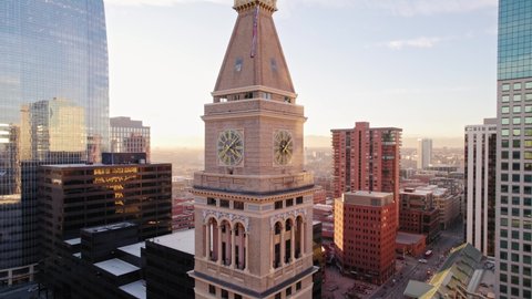 Drone Aerial View Flying Up Showing Lannies Clocktower Landmark Structure In Downtown Denver Colorado During Golden Hour Sunset