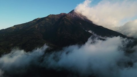 Aerial view of Mount Merapi during the day shrouded in fog in Yogyakarta, Indonesia.