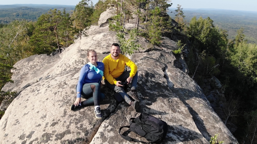 Aerial view of the rocky massif, Arakul Shikhany, Ural. The mountain elevation is located among dense green forest near lakes. Clear weather. Hiking, tourism, wild nature