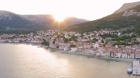 Aerial boom shot of a quiet village on Krk Island Croatia early in the morning.