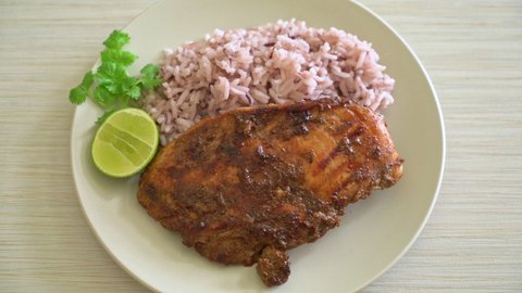 spicy grilled Jamaican jerk chicken with rice - Jamaican food style
