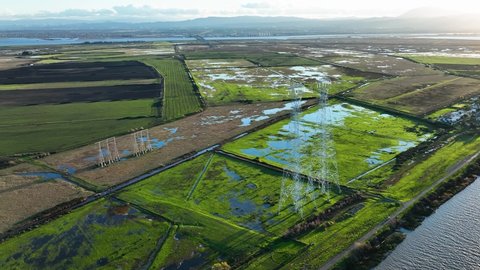 Aerial view of Sherman Island Marshy fields and Electric power lines on Wild Life Area, California